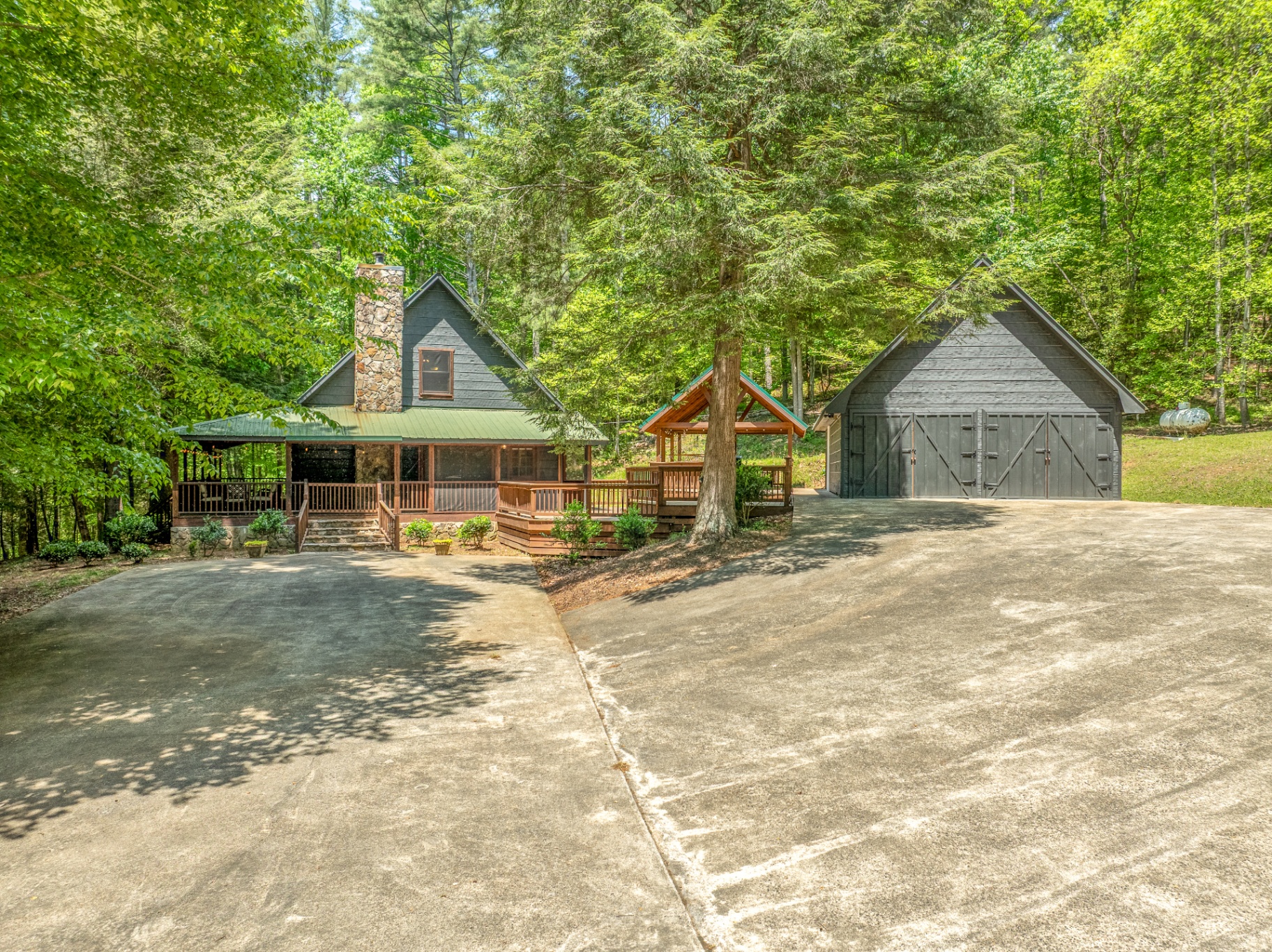 Twilight view of the ElliJAYbird cabin glowing in the North Georgia forest