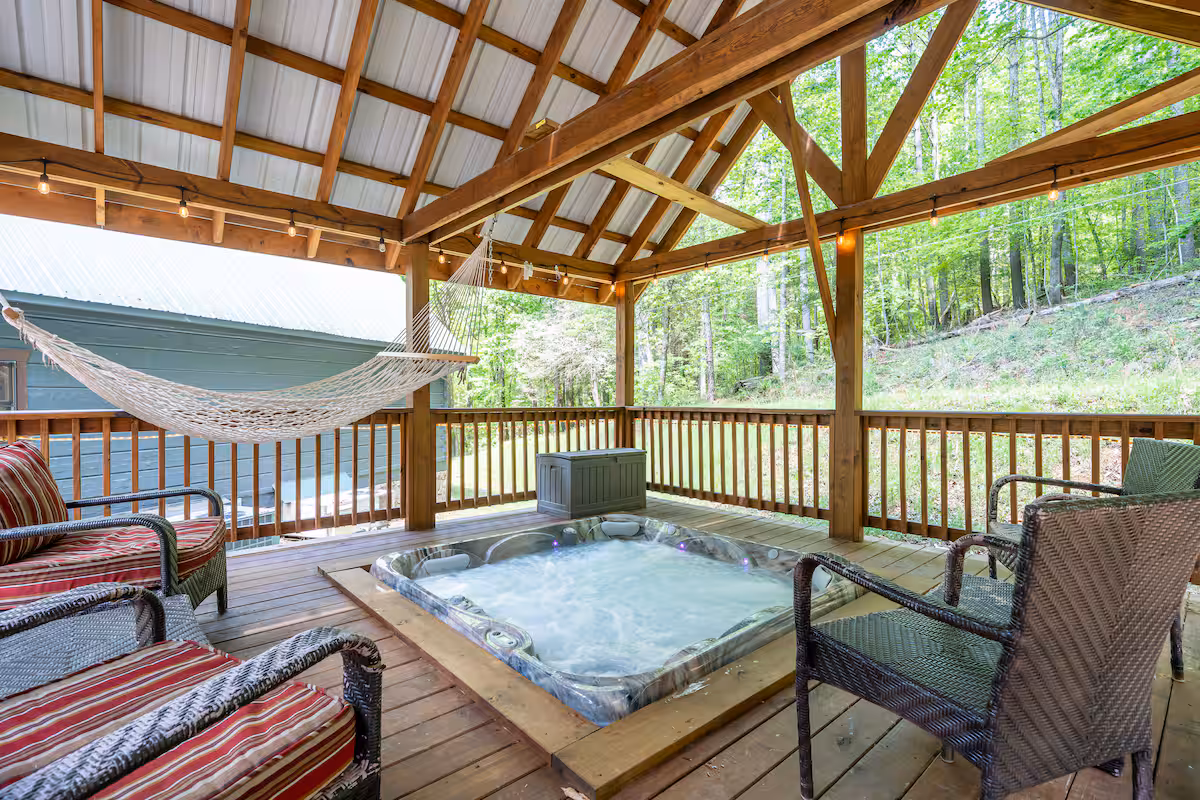 Hot tub on the covered deck surrounded by mountain views