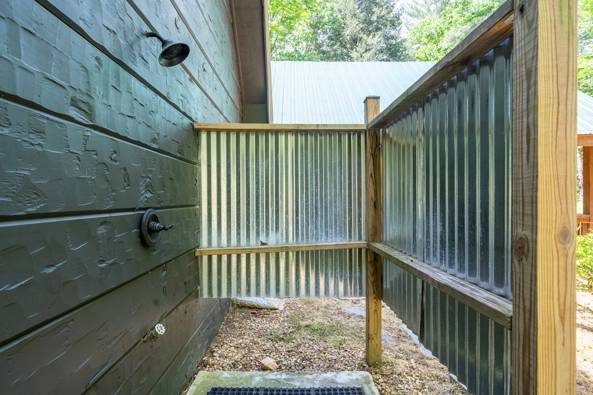 Private outdoor shower on the side of the cabin