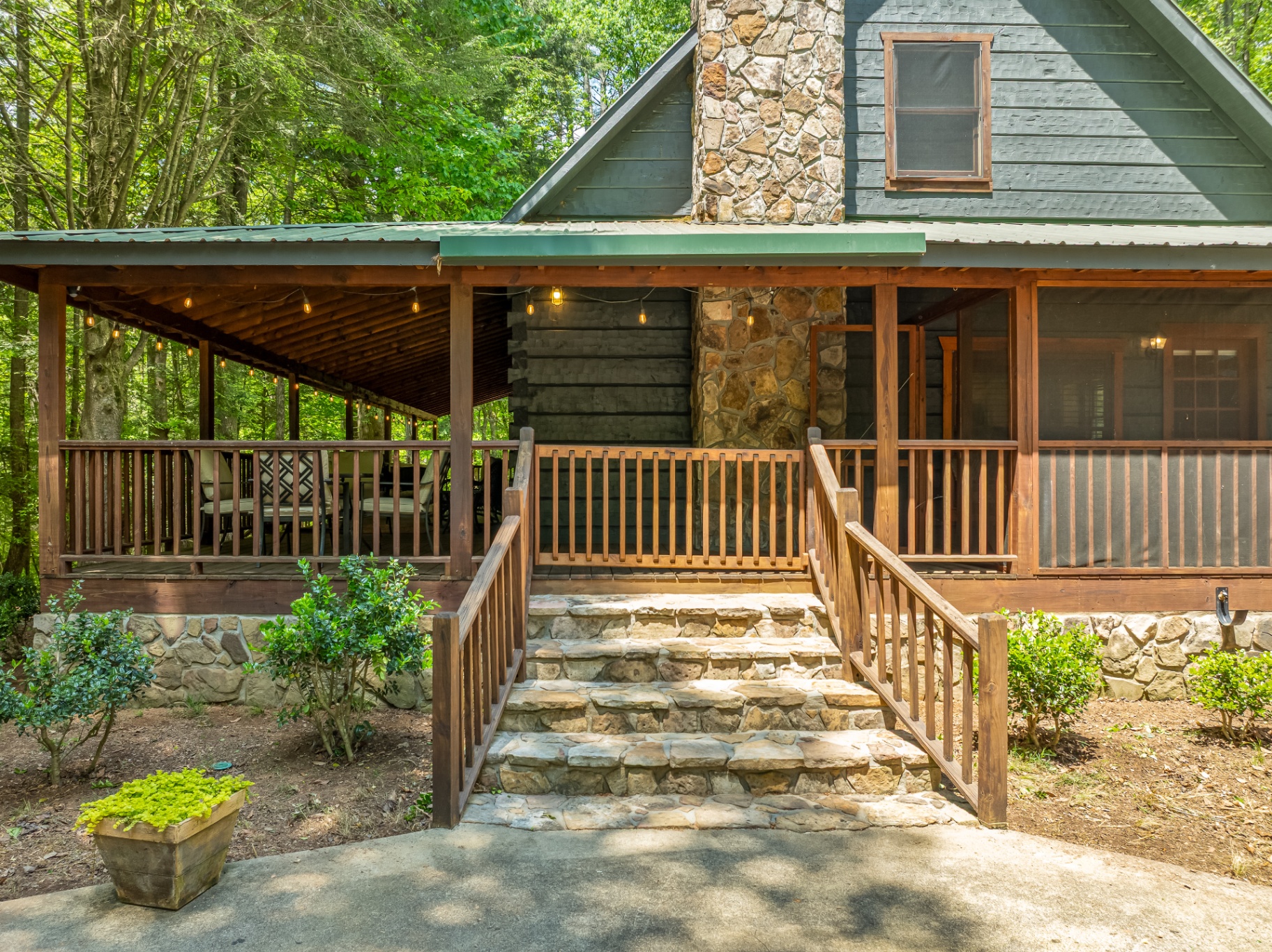 Front porch with screened-in seating overlooking the creek
